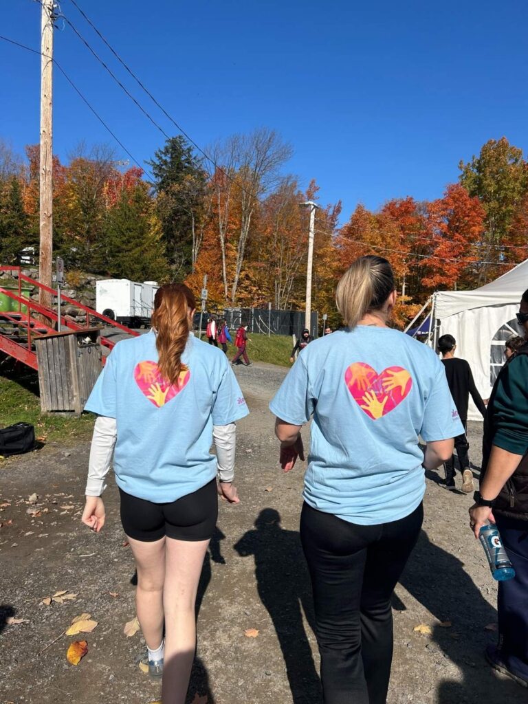 deux employés ont de dos au bromont ultra et ont un chandail du CPSC
